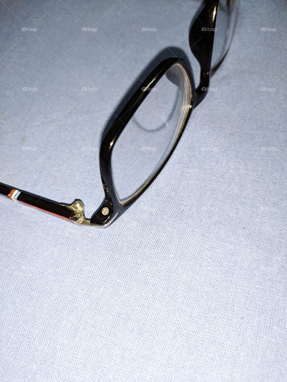 an old man spectacles on the closed table top
