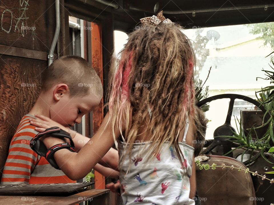 Brother And Sister Playing. Young Children Playing In Their Treehouse
