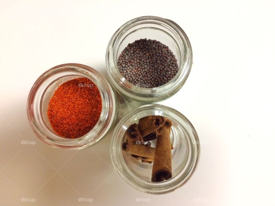 Three condiments in glass containers