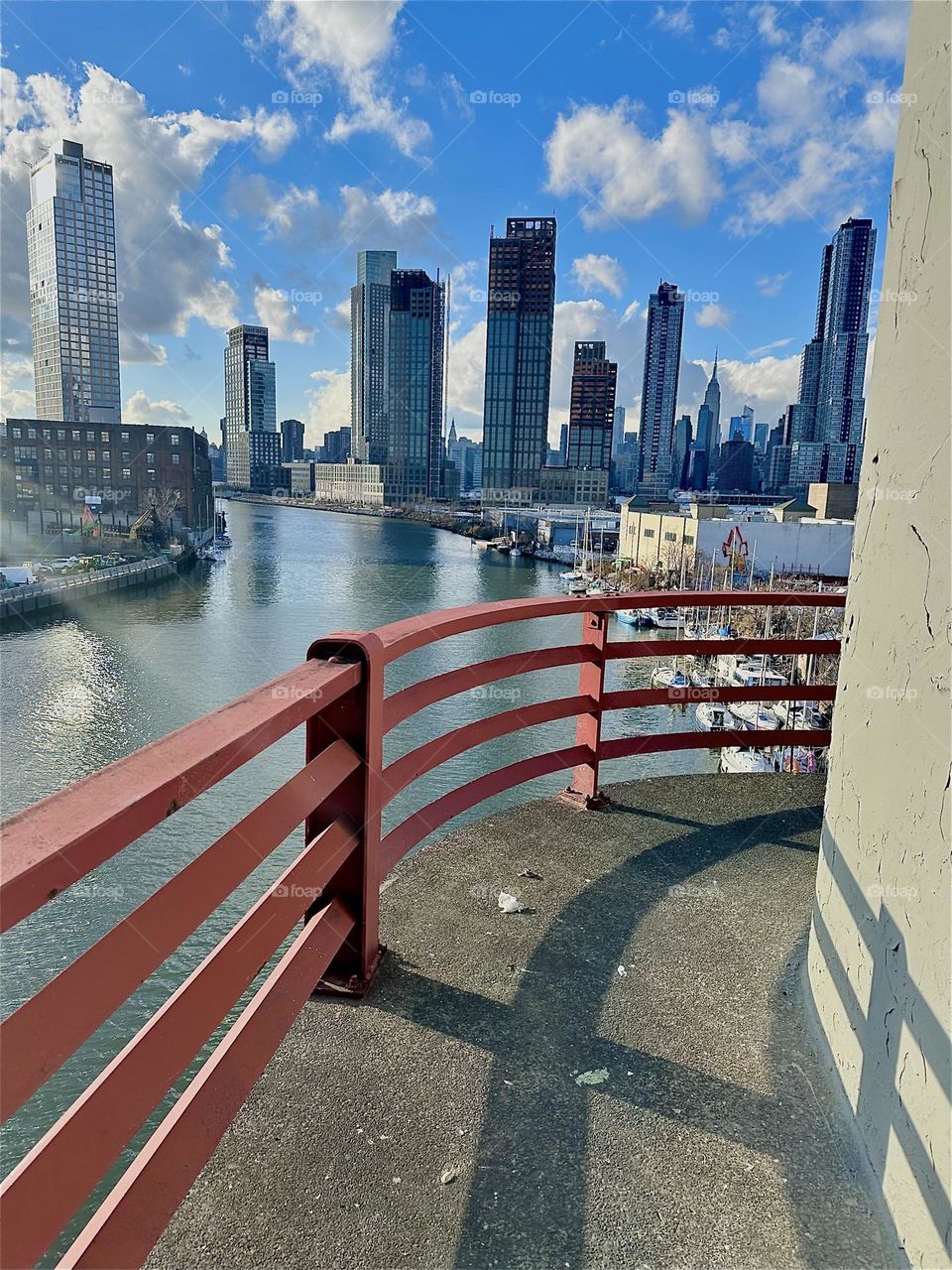 This is the gorgeous view from the central outpost on the “Pulaski Bridge” at “Newtown Creek” that connects LIC, Queens to “Greenpoint”, Bklyn. In the distance we see LIC and “Manhattan” incl. the “Empire State Bldg”. 2023. Hypnotic Productions