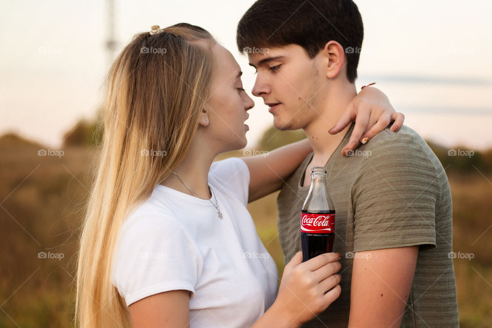 Close-up of two lovely couple with soft drink