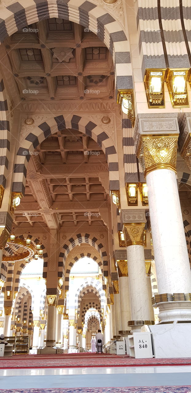 This photo is from inside the Madina Holy Mosque in Saudi Arabia. It is the mosque of Prophet Muhammad (peace be upon him), the Prophet of Islam and muslims. 

The photo can be used in Islamic events and in historical architecture, & worship places.