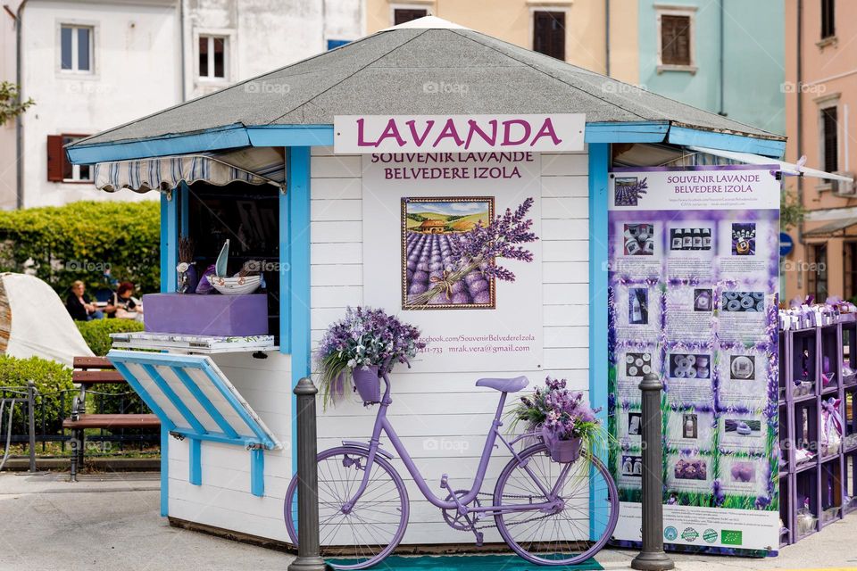 Purple bicycle at a street stall with souvenirs