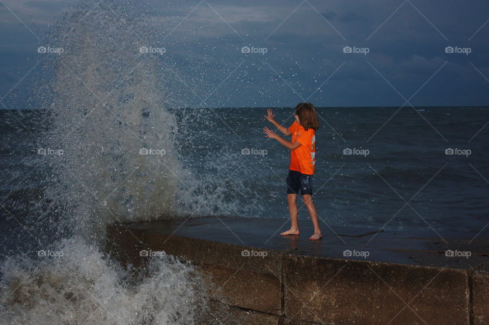 Making a splash. A wave breaks at Lake Erie ,  tempting fate