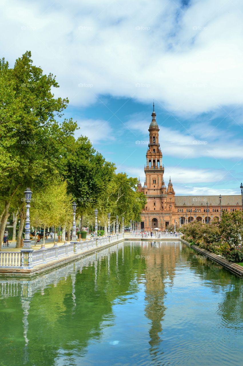 North Tower and reflection. View of the north tower and river at Plaza de España,  Seville, Spain.