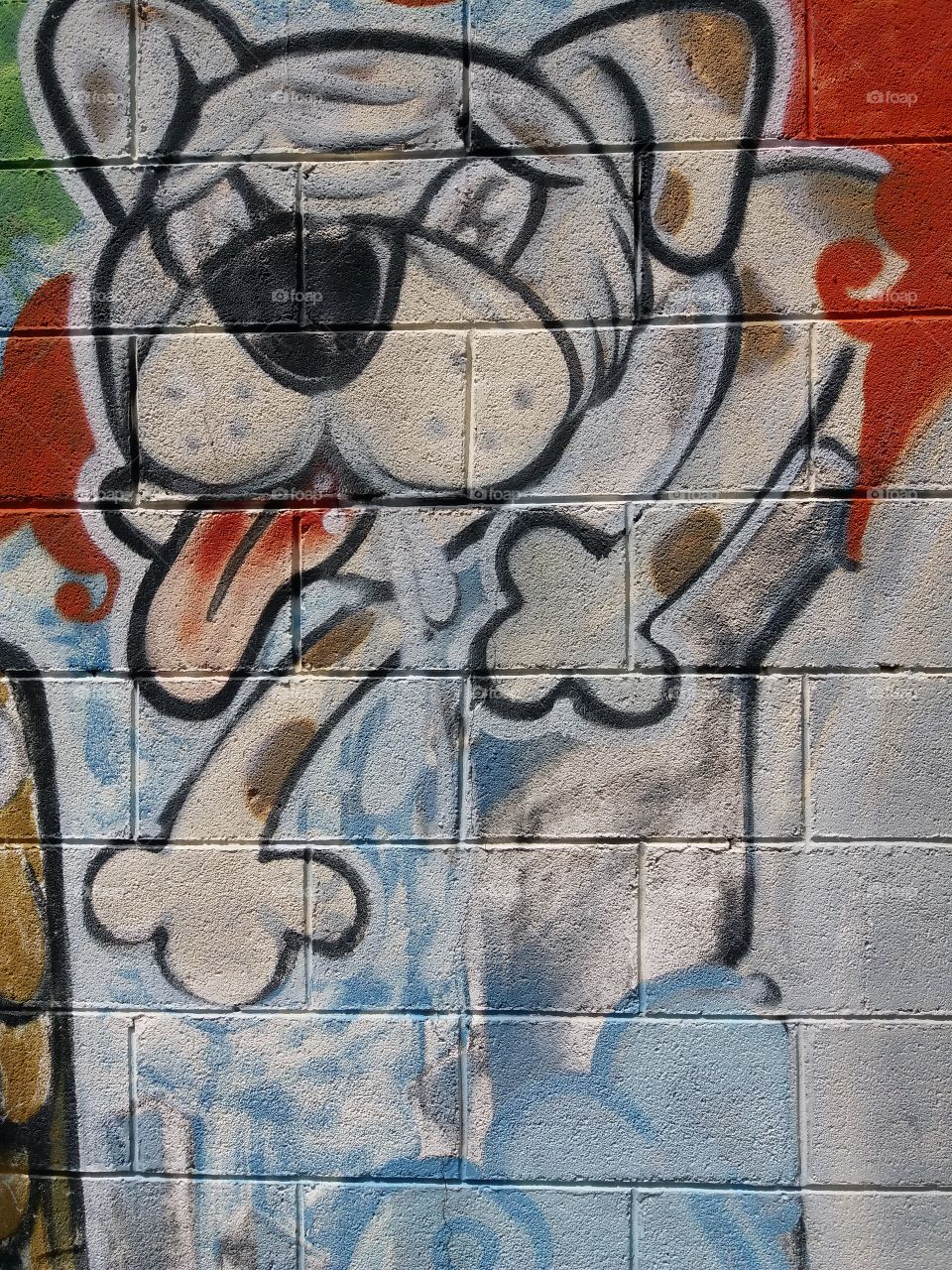 dog spraying art at the wall