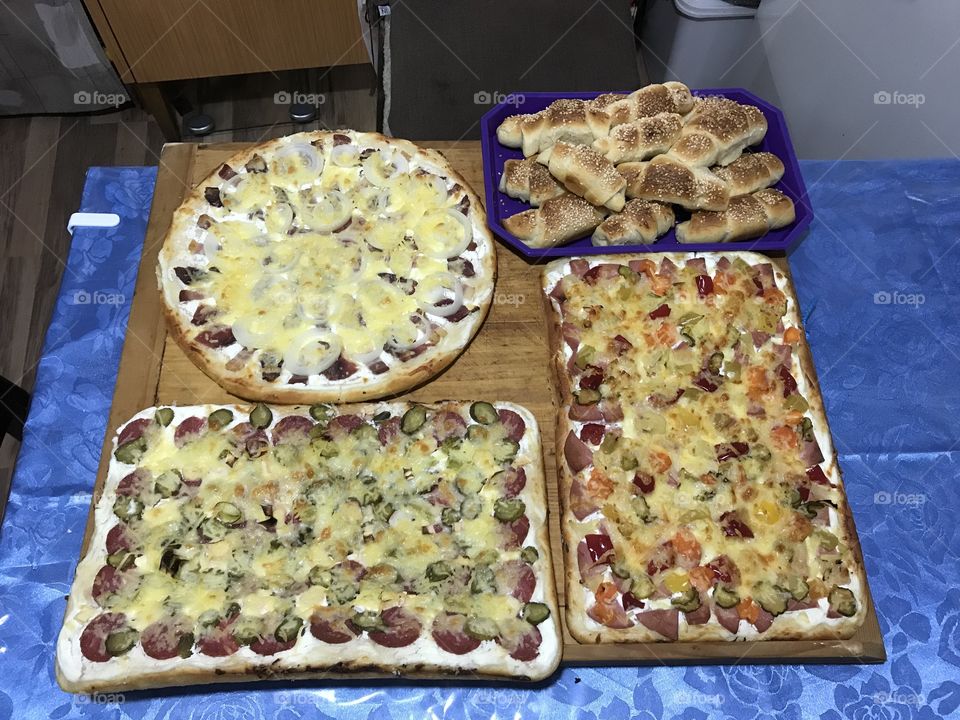 Homemade rolls and pizzas.