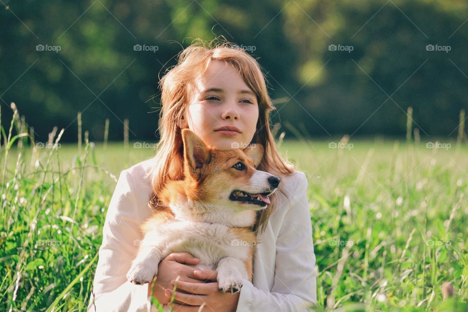 Girl and a dog on a field