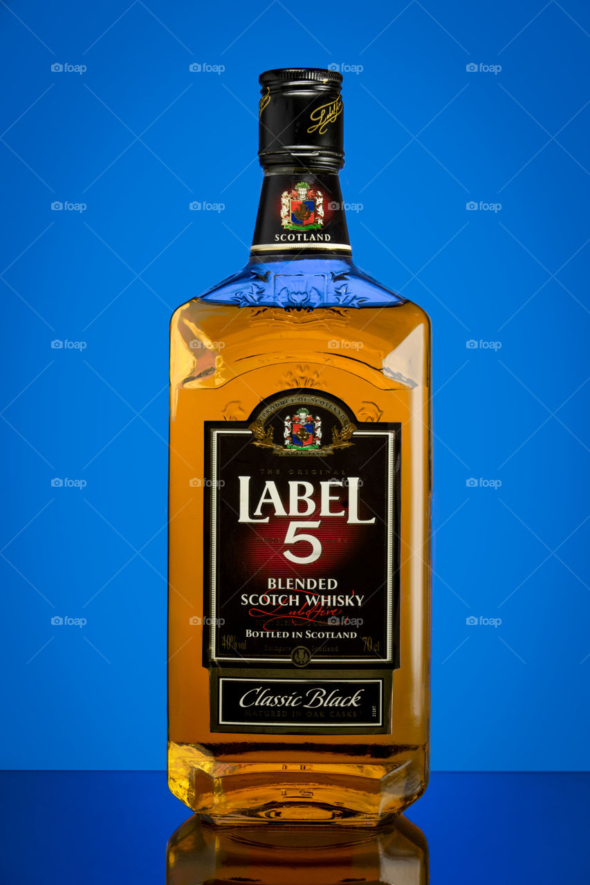 label 5 whisky on blue background