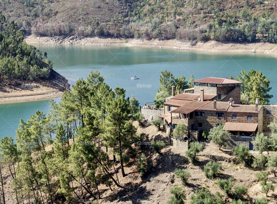 Stone buildings look out over the Rio Zêzere at Zaboeira 