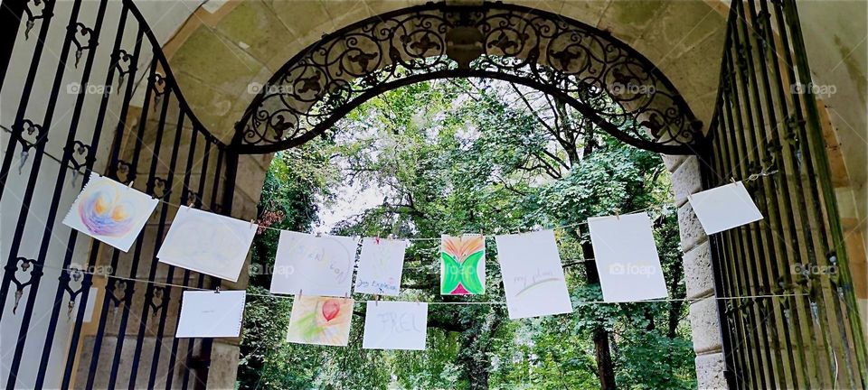 Flyers strung up on a rope across the arched stone entranceway of the old castle of “Steinach” in “Lower Bavaria”, Germany invite to the “Market of Possibilities”, a local arts and crafts fair with various events. 2024. Hypnotic Productions