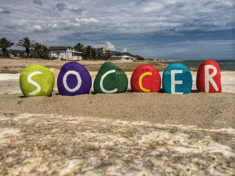 Soccer concept on colorful stones