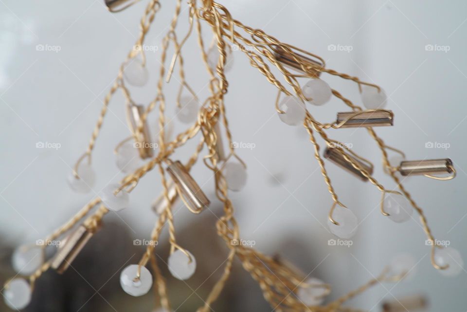 Beads cascading on the side of a jar of rocks