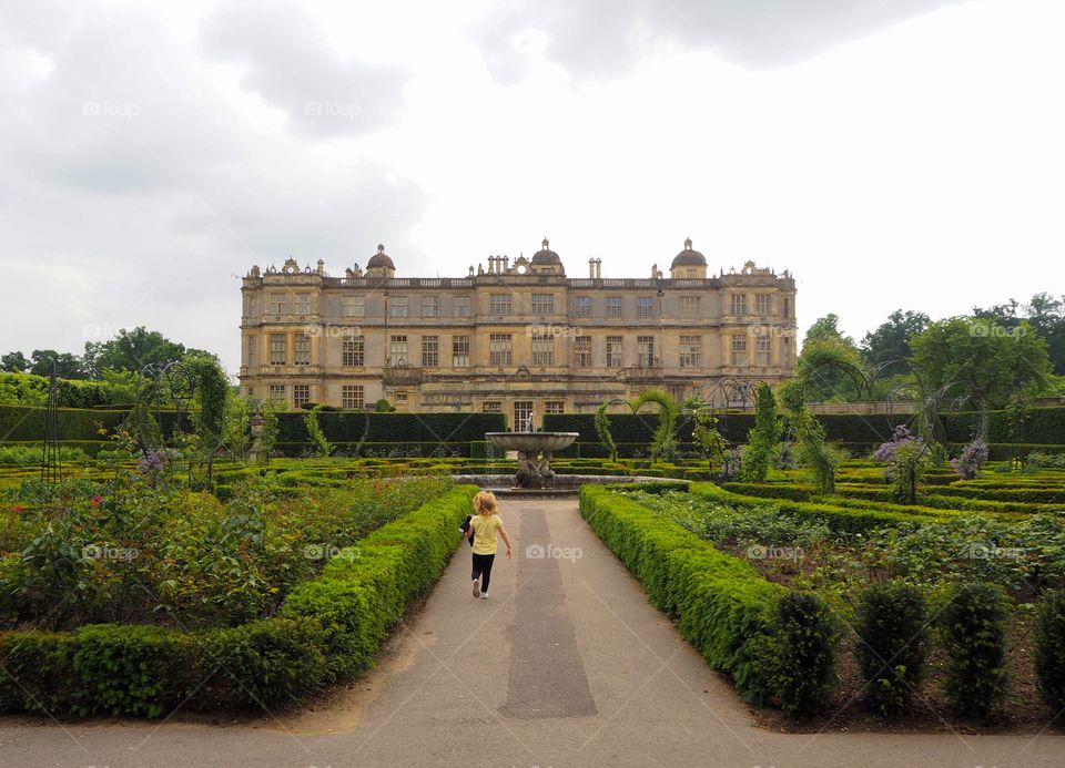 Child running towards Longleat house