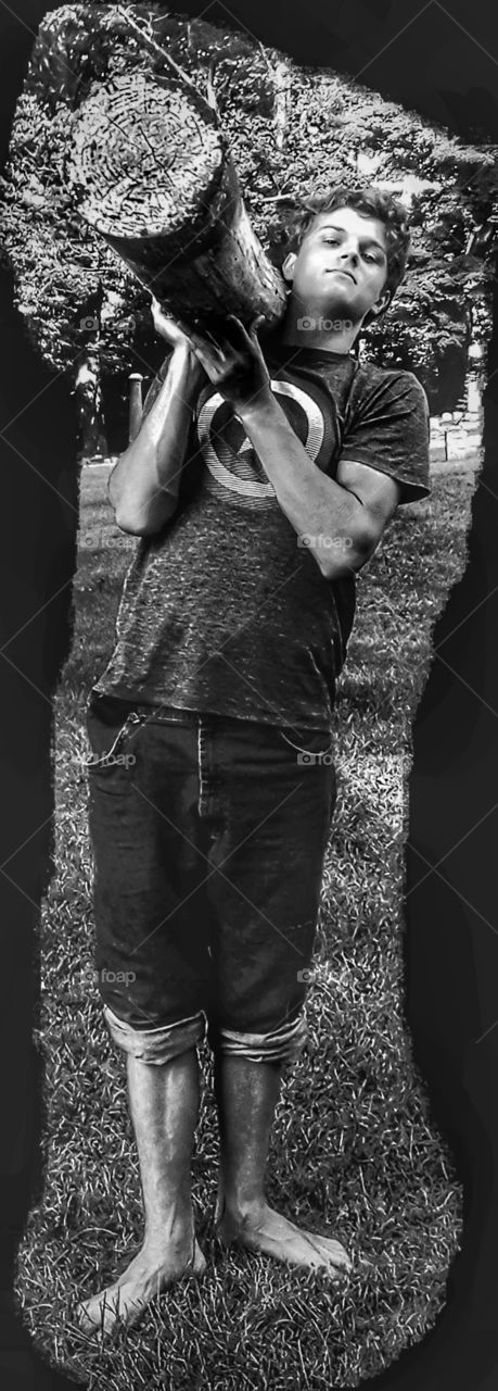 young man holding log