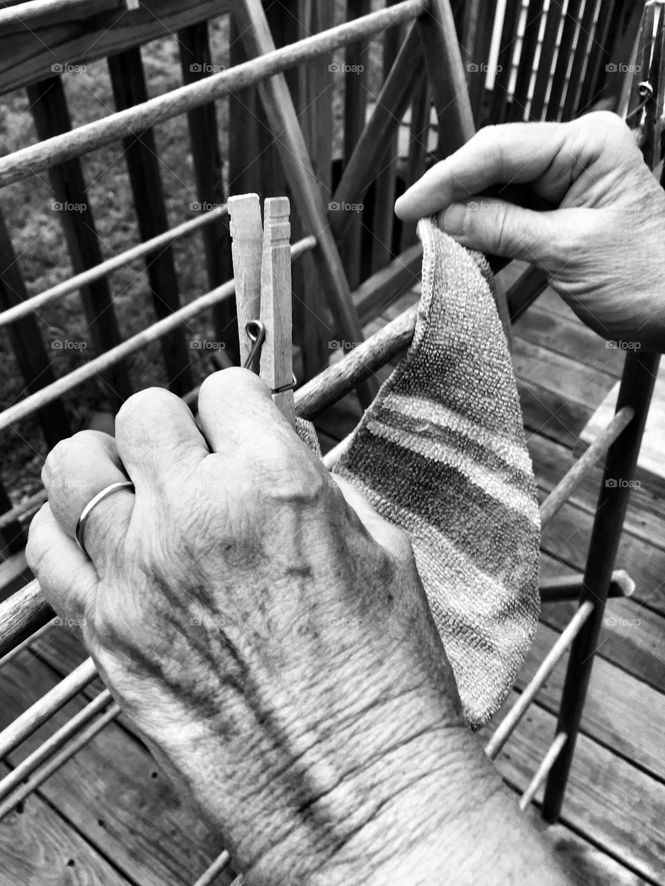 Aging hands hanging laundry 
