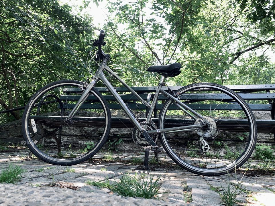 Isolated bicycle leaning on the bench Central Park New York.