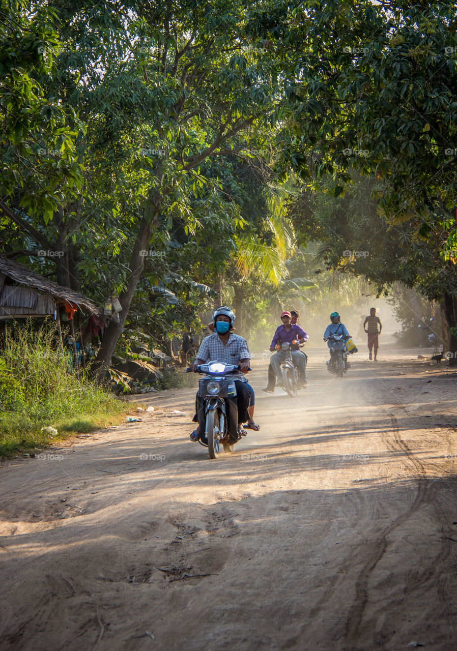 Motorcycles on a dirt road at dusk