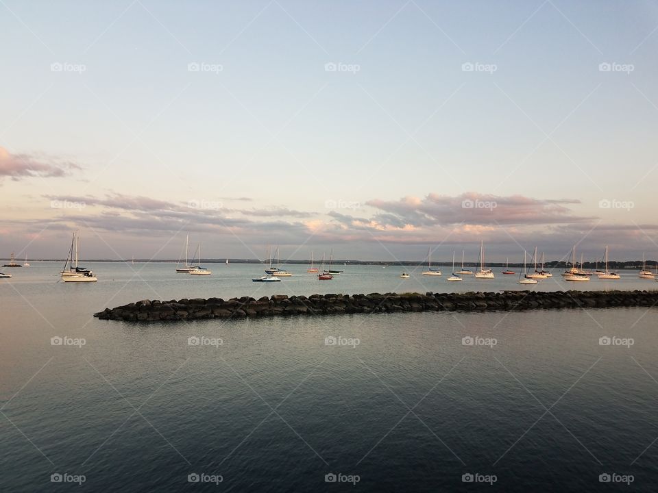 Fleet of sail boats sit in the Raritan bay in Perth Amboy, Nj.