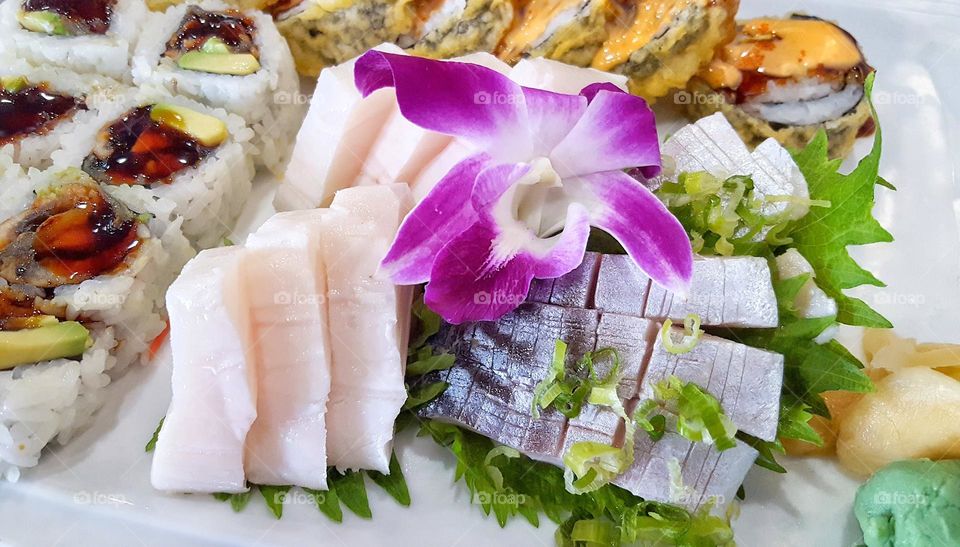 Sushi and Sashimi Assortment with flower garnish