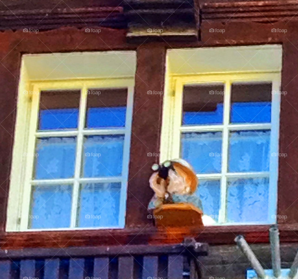 zermatt a fake little man. watching with binoculars by swisstraveler