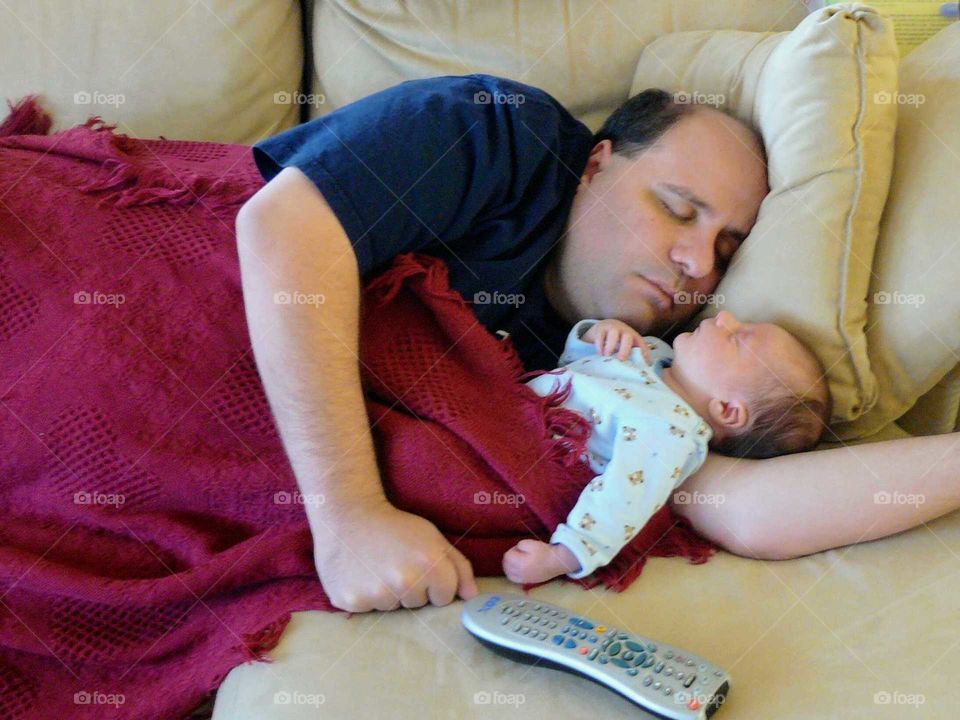 Father and baby napping