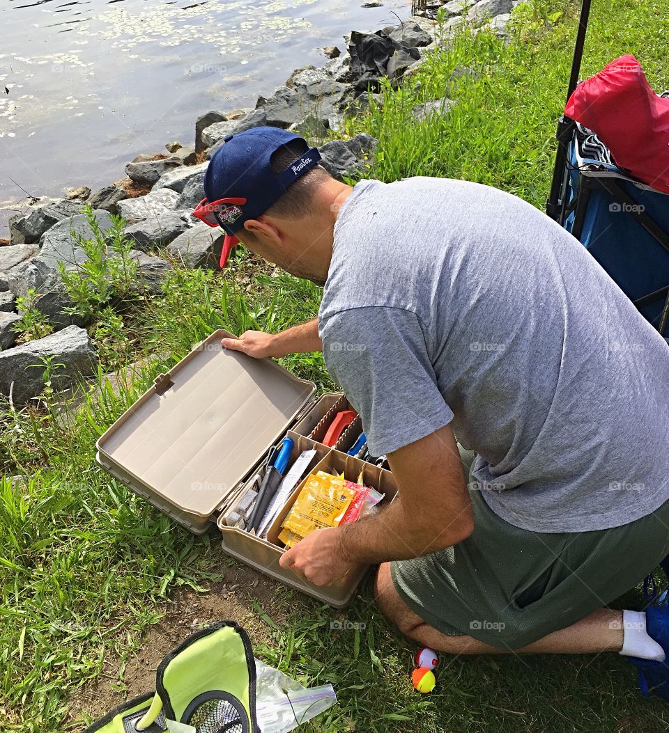Setting up to start fishing at a local fishing derby.  Getting the tackle box ready for action. 
