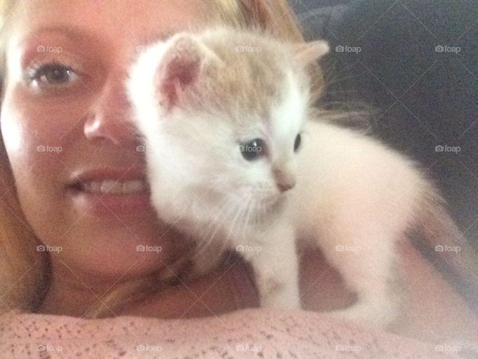 Beautiful young woman with cute cat resting at home