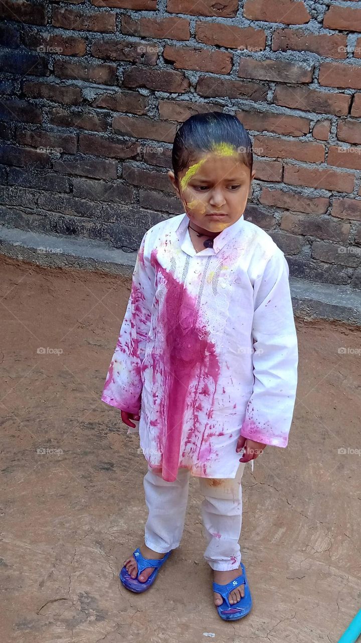 A beautiful girl,his clothes are coloured, red strip on his withe gown looking so beautiful. photo shoot at mon, 1may, 2023, 10:09 am.