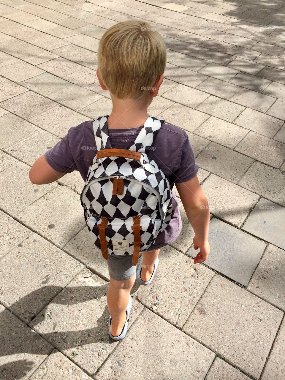 Boy with squared patterned backpack