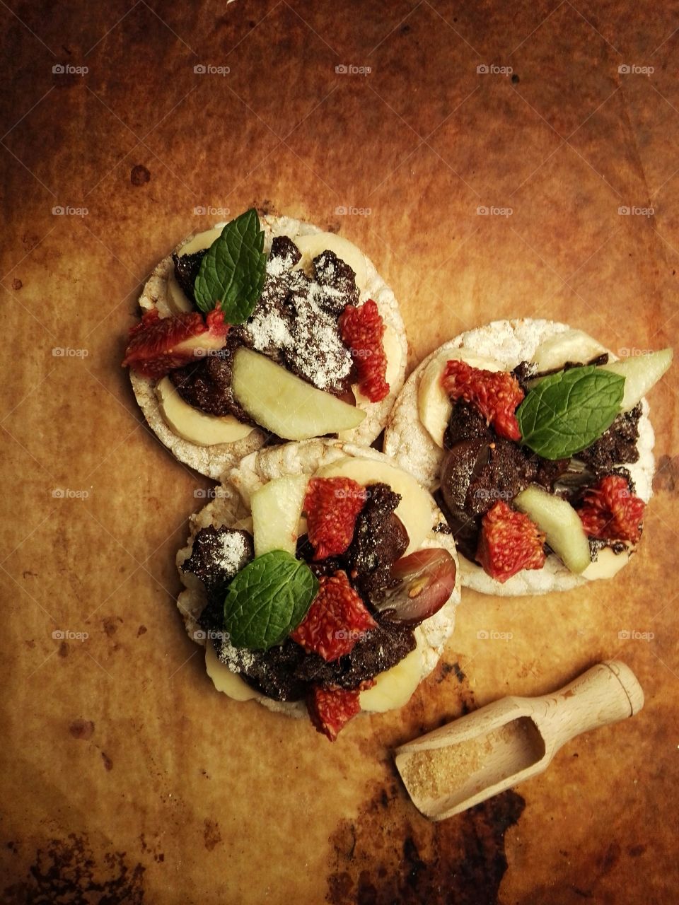 Healthy sweets with fruits and dark chocolate on a rustic background