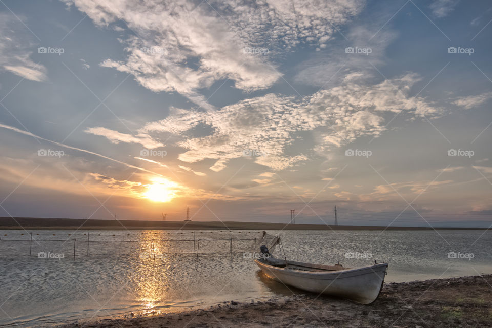 A boat at the lake sunset