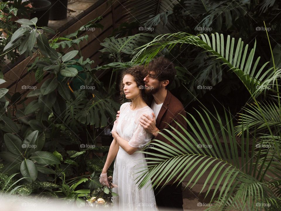 Beautiful lovers in botanical garden 