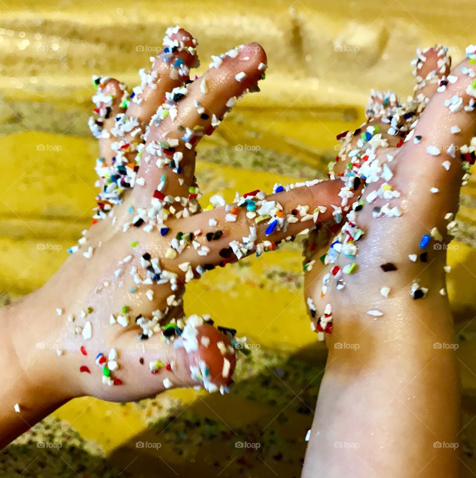 Kids hands playing with plastic sand