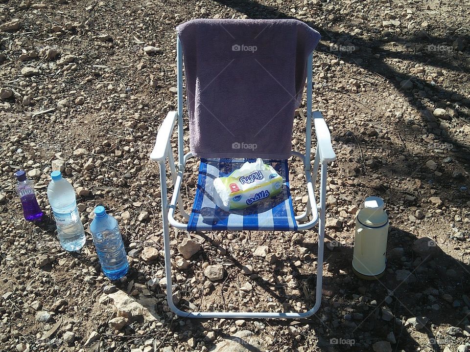 A chair and bottles in area.