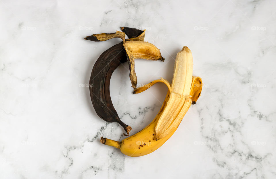 Two bananas on the marble background. Concept of zero waste life.