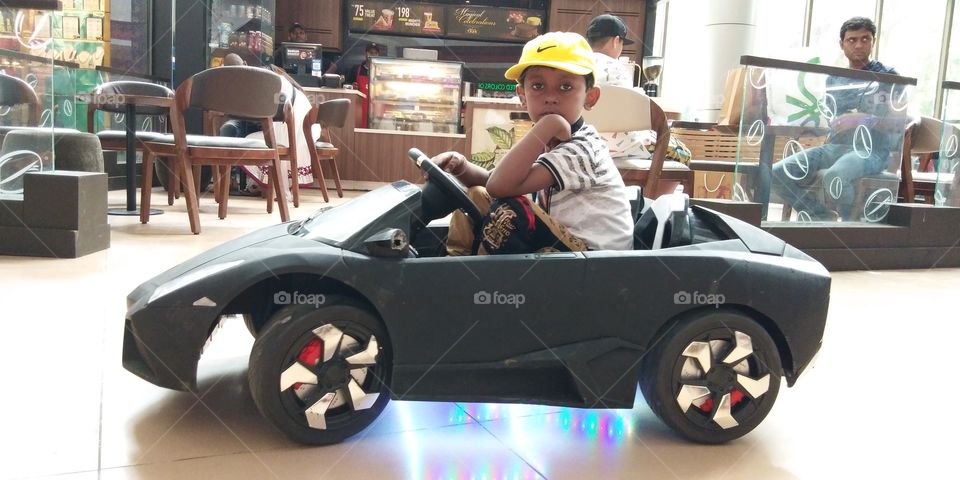 kid driving car , car toy driving,indian boy driving car