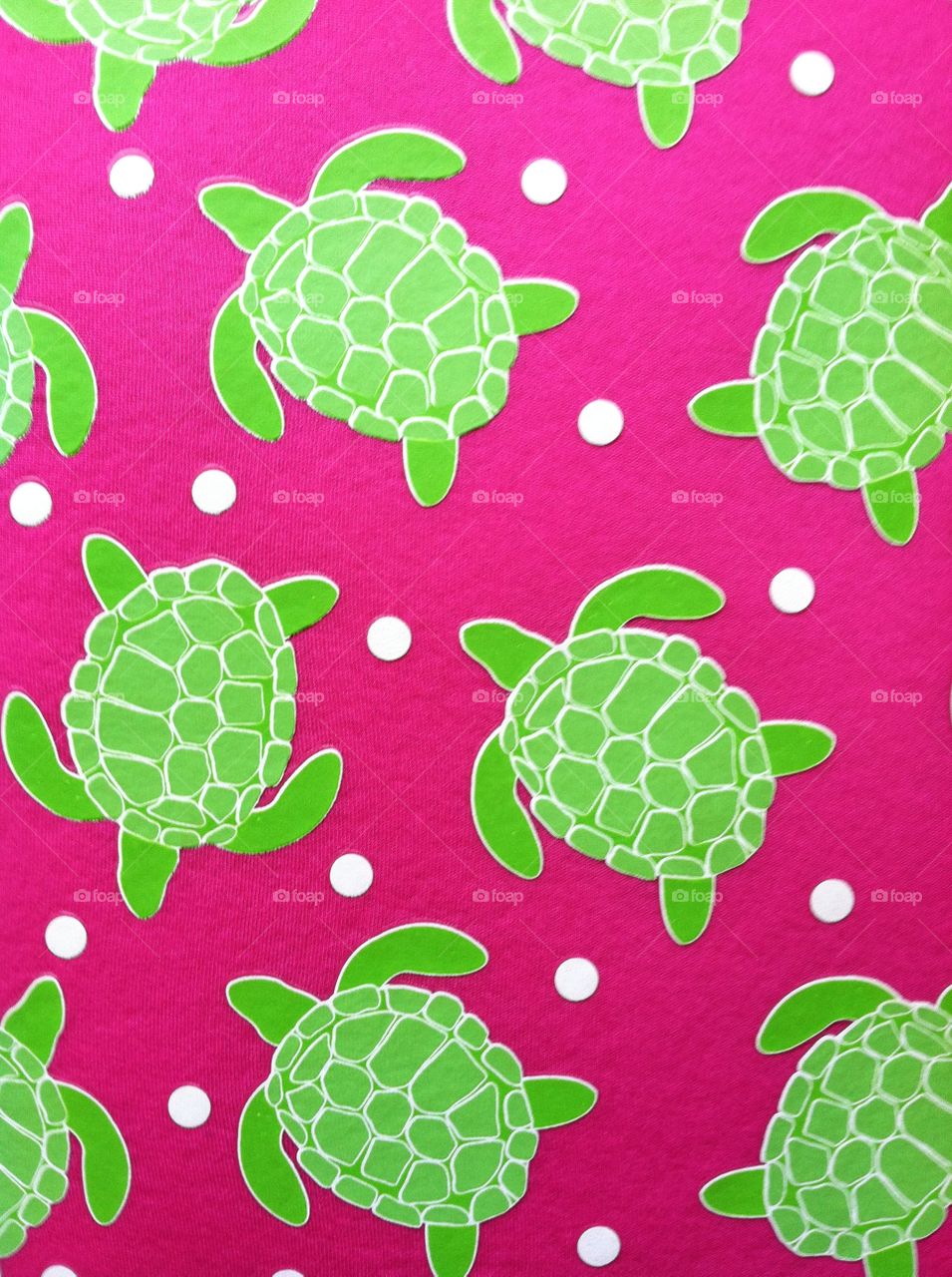 Bright green sea turtles against a bright pink background.