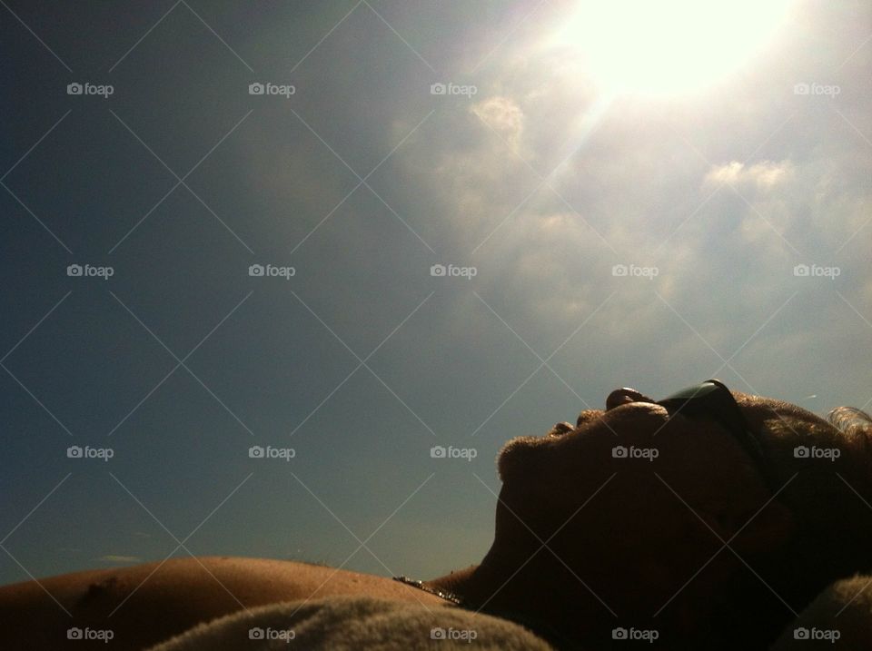Man Laying in the Sun on the Beach