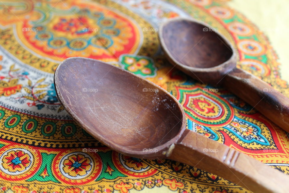 traditional wooden spoons on coloured towel