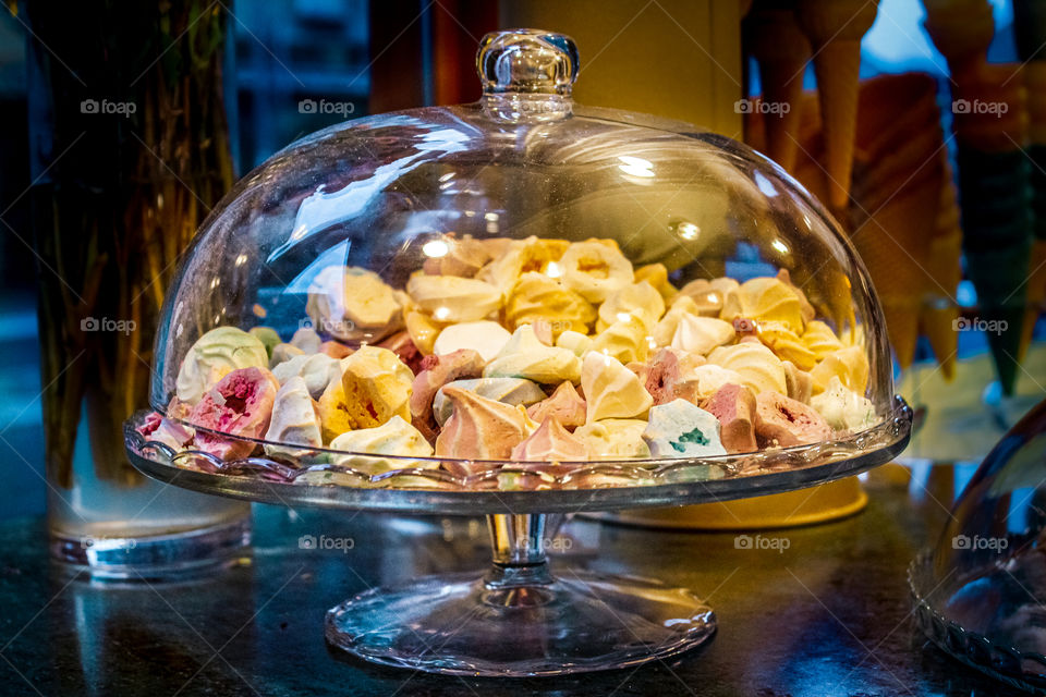 Pastry shop - "puslica cakes under an oval glass lid on a raised up plates"