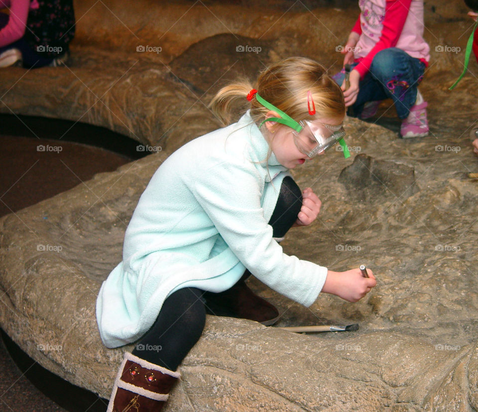 Little girl exploring rock