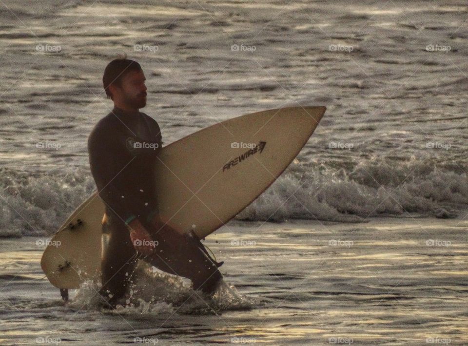 Surfer Entering The Waves. California Surfer