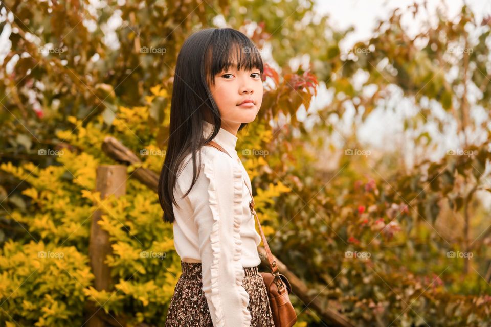 It's Autumn time, so is the time for some beautiful portraits, portrait of a young little girl with vibrant Autumn colours in the background.