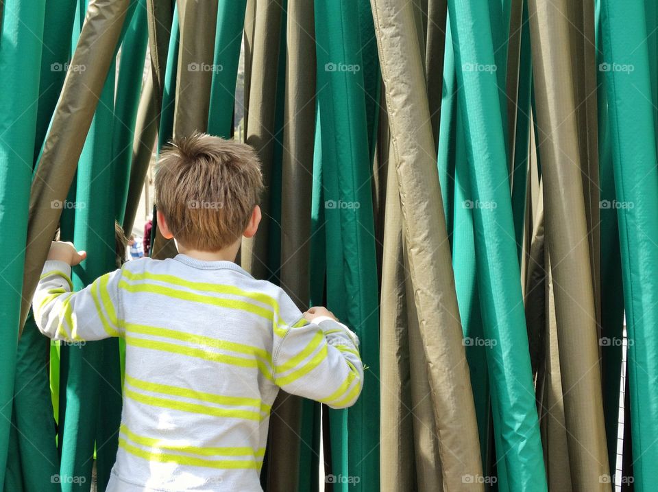 Entering The Unknown. Young Boy Exploring A Maze
