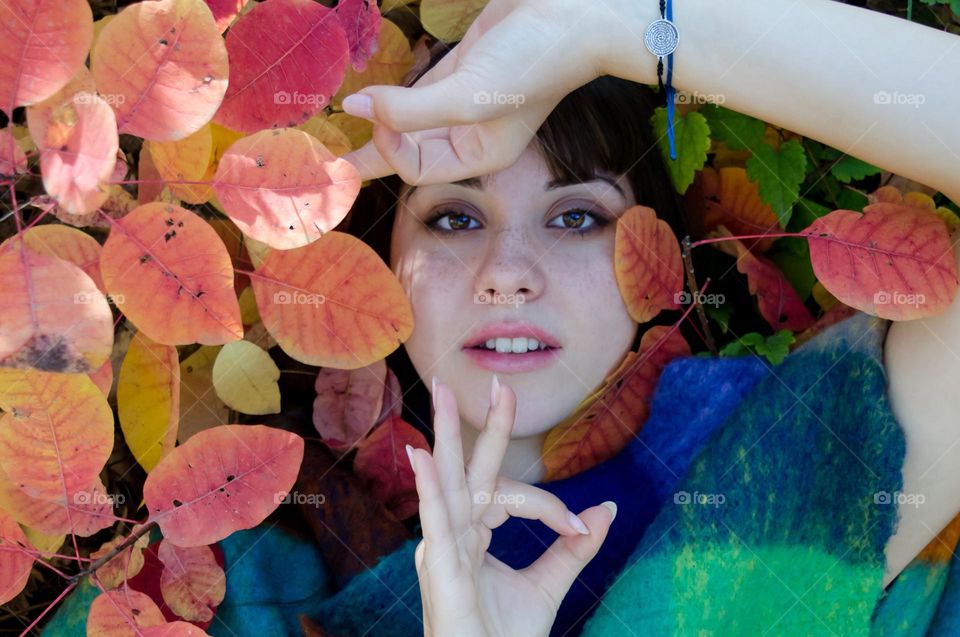 Portrait of a Beautiful Young Girl on Autumn Background