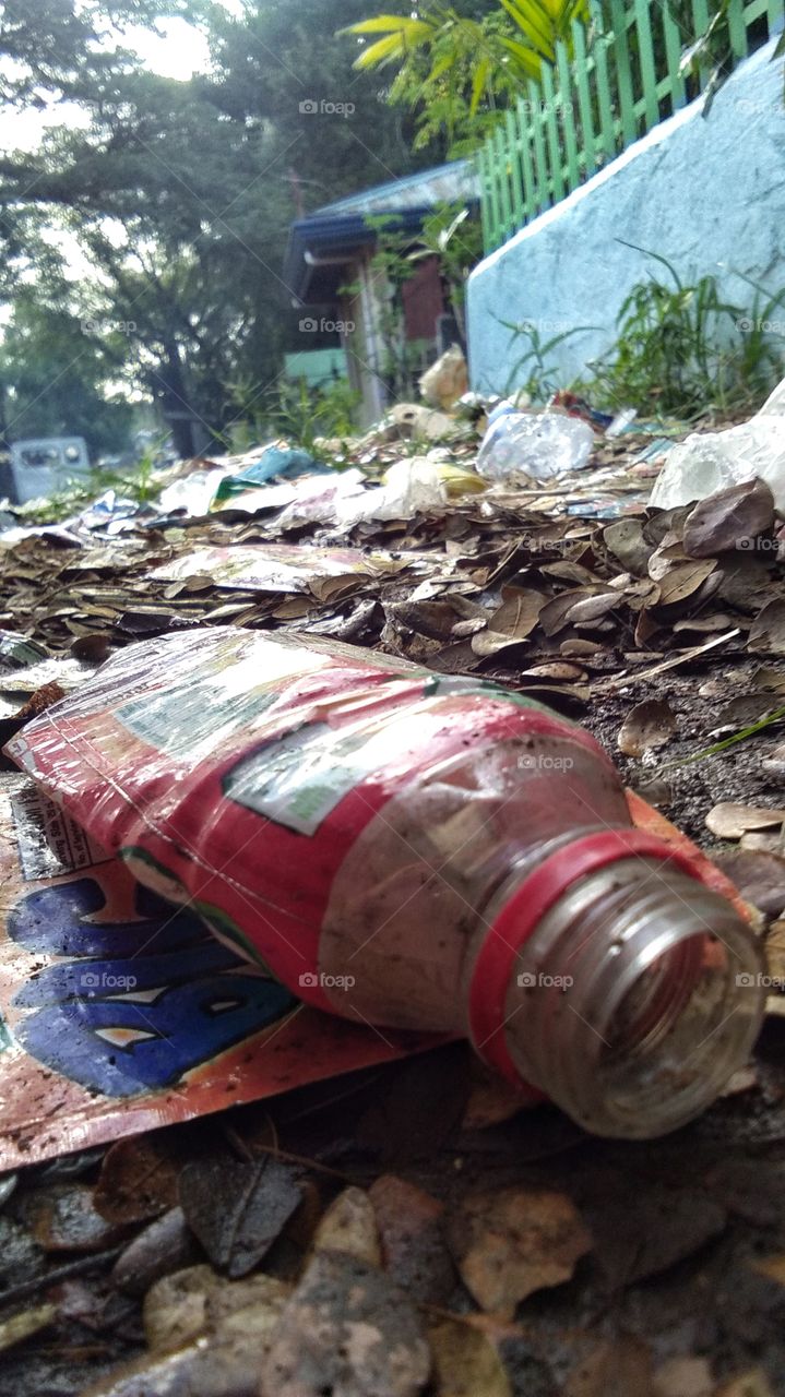 Here's a picture of a water bottle being thrown not in the proper area together with other trashes.