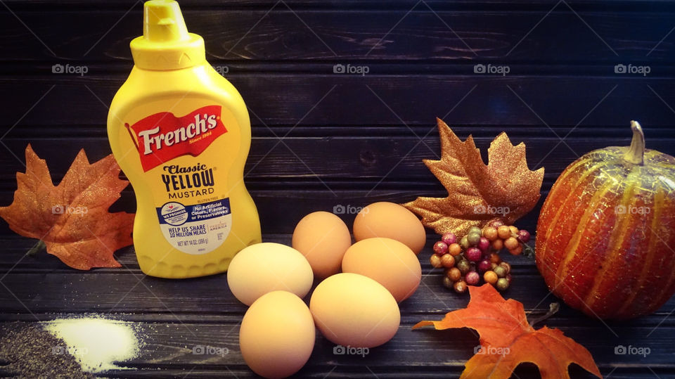 Ingredients for deviled eggs including eggs, mustard, salt, and black pepper. Thanksgiving appetizer or side item idea. 