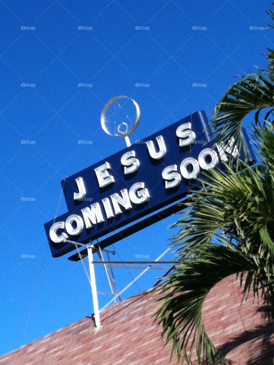 Looking Up at Sign . Message on Sign against blue sky 