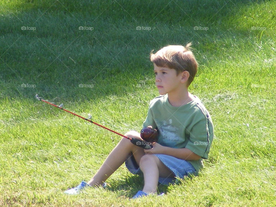 Boy holding fishing rod in hand